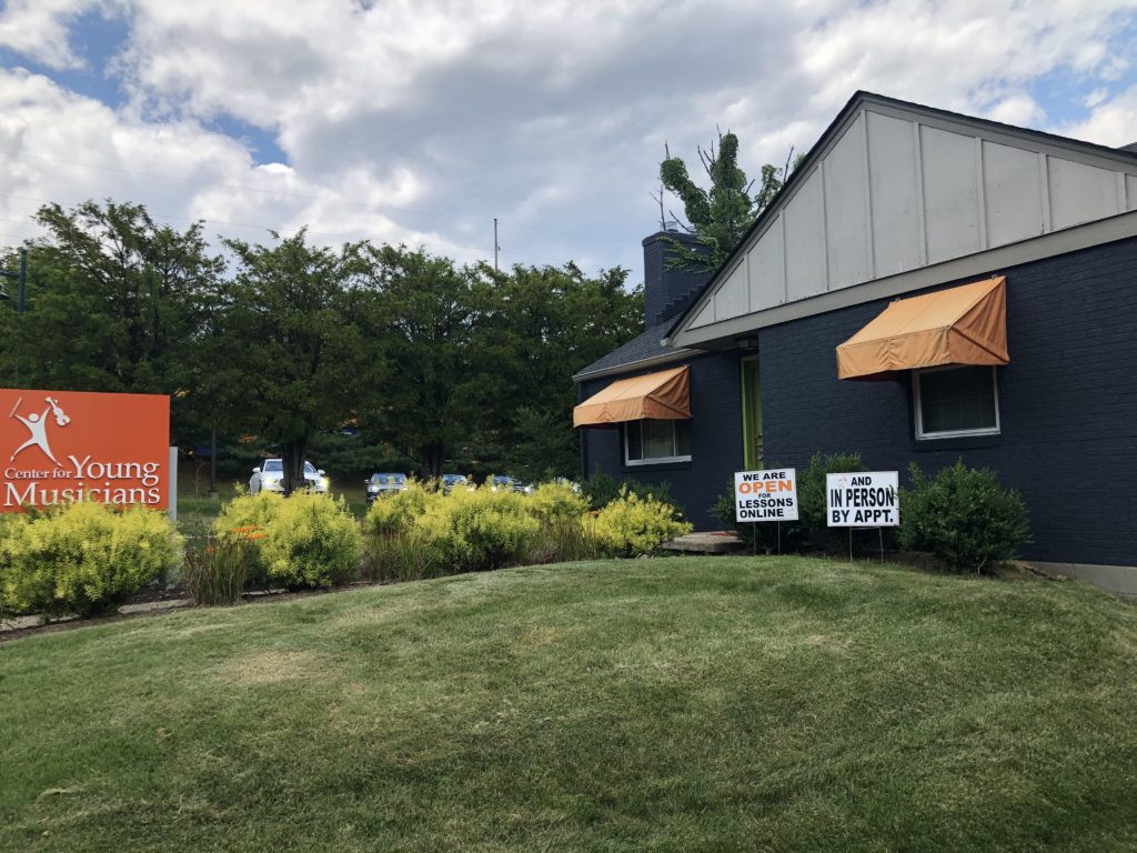 Wide shot of Wexford building with signs in the front yard