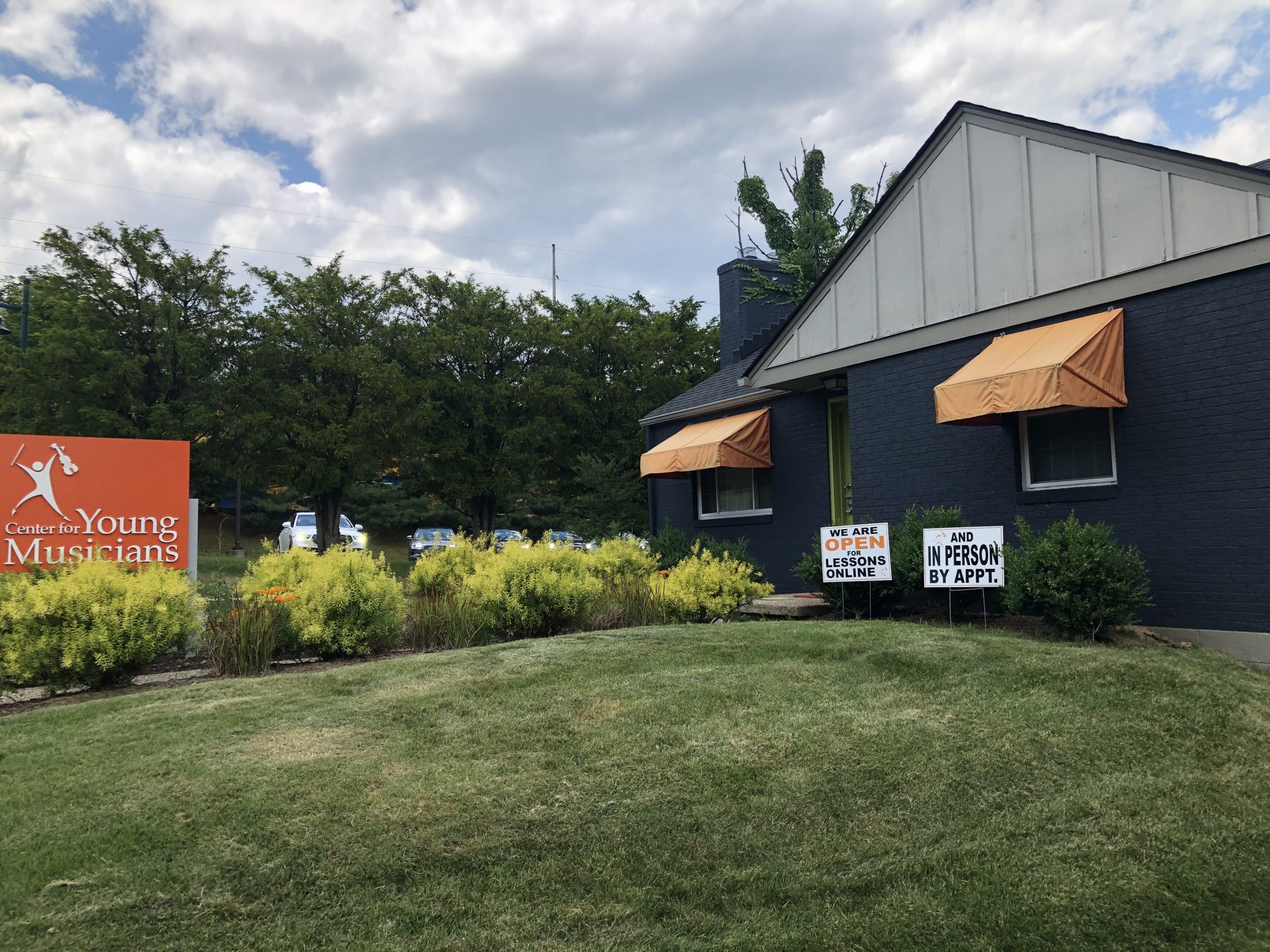 Wide shot of Wexford building with signs in the front yard