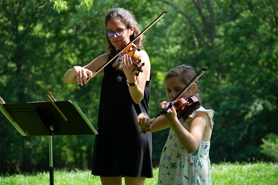 Leah and student playing