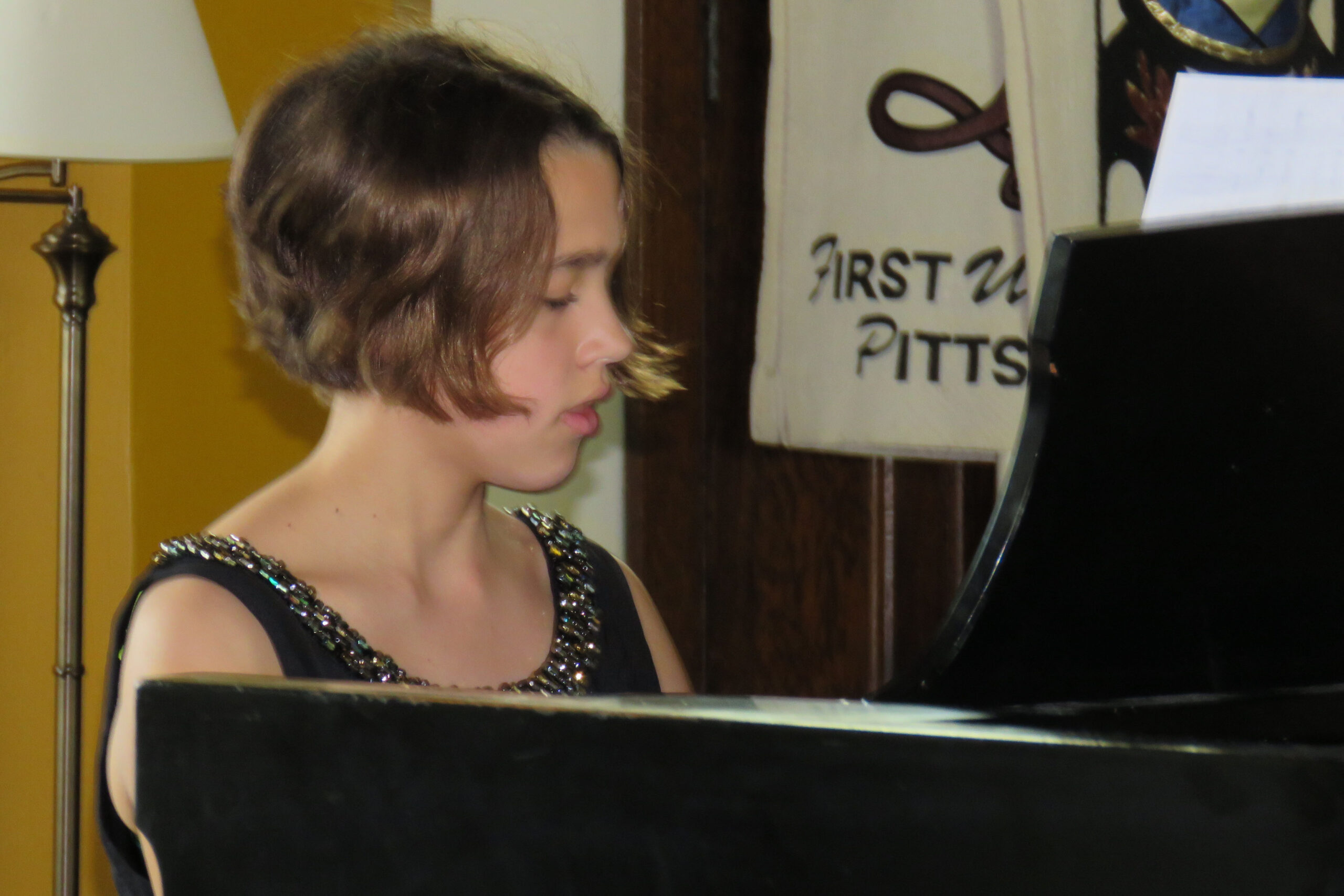 Marissa playing a piano at the first united church