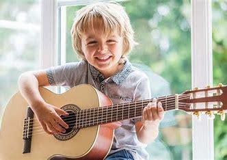 Child learning to play the Guitar